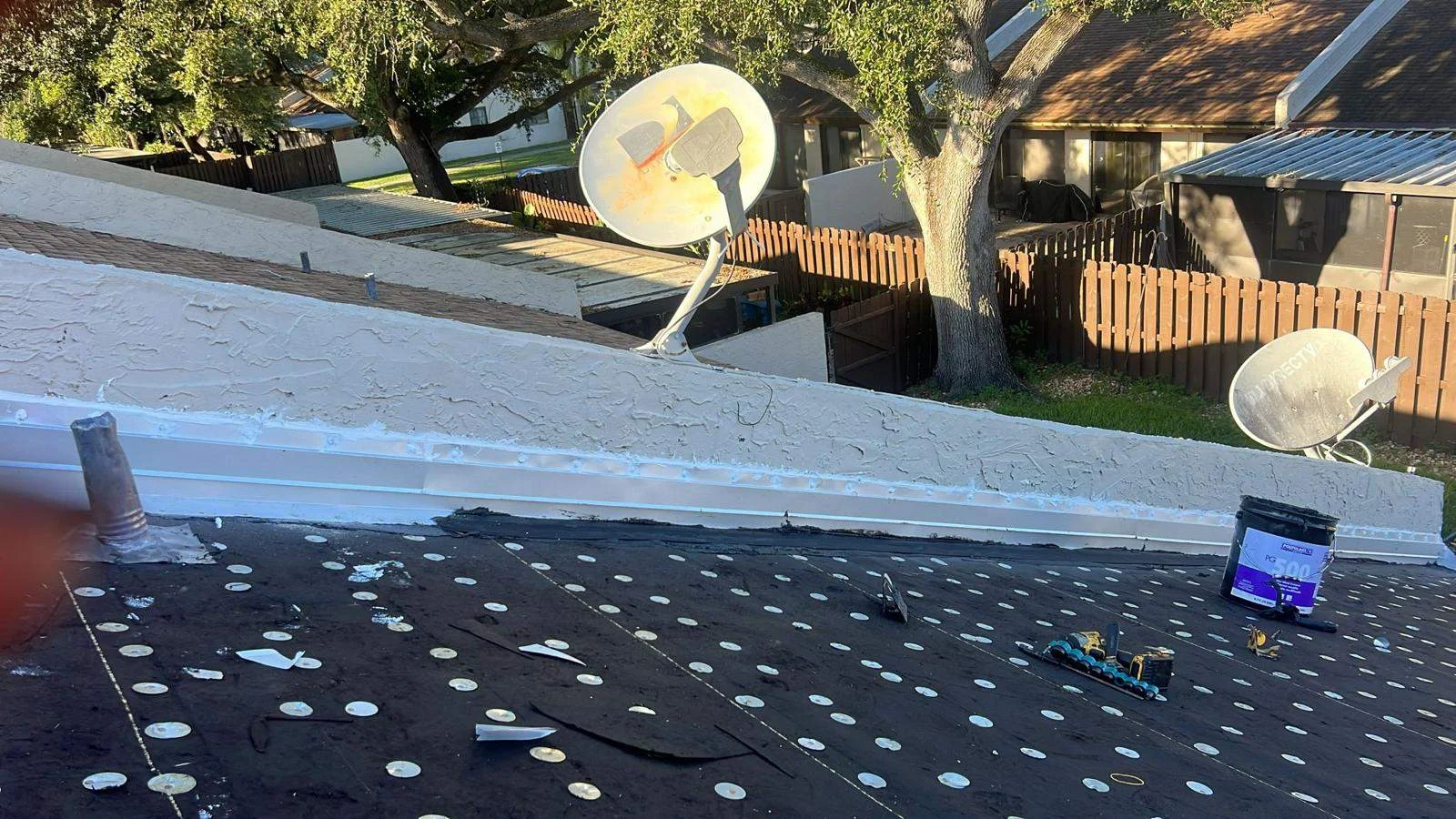 Roofer's perspective of completed roof installation with ventilation components visible.